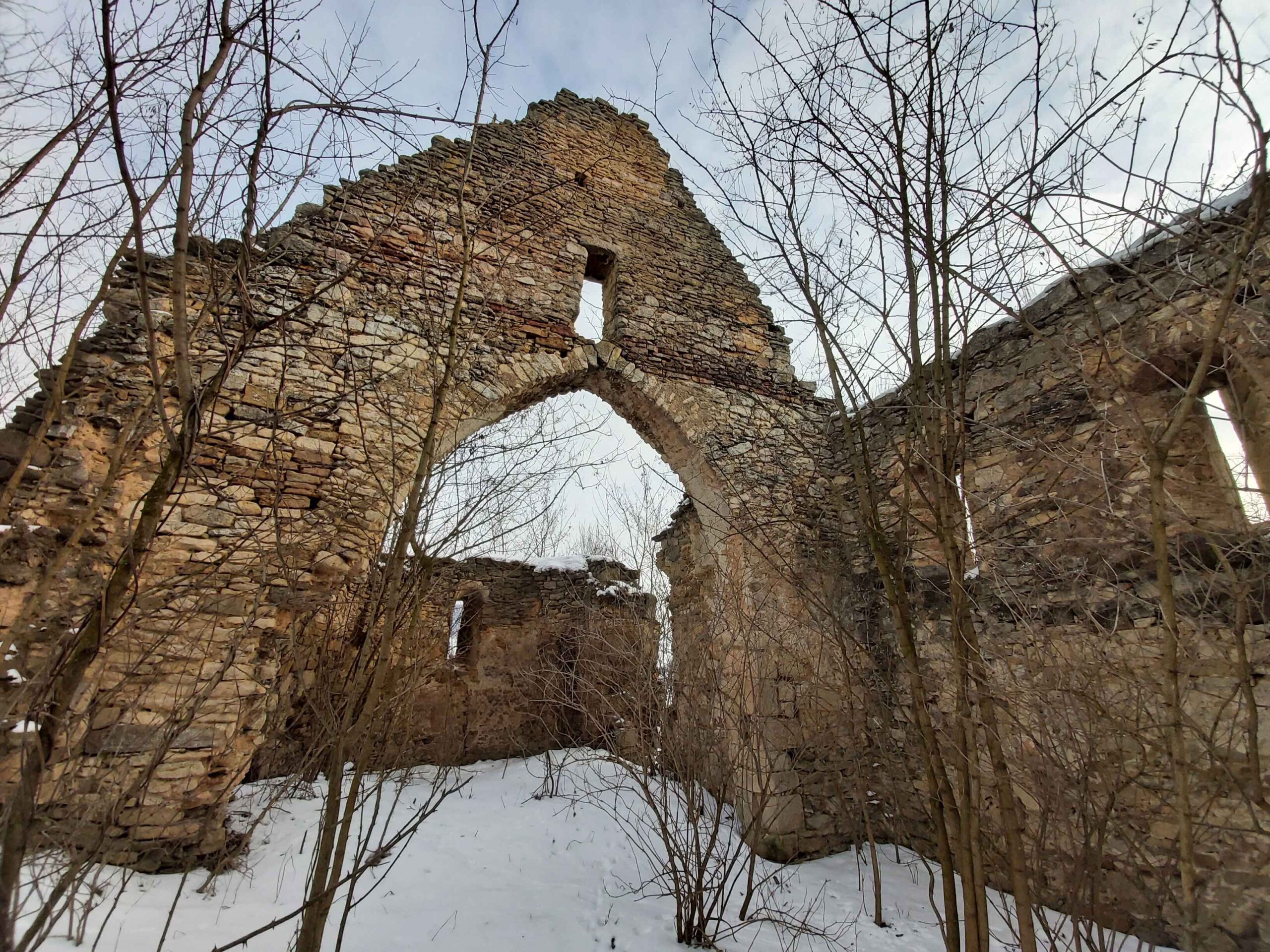 Ruined church behind the house. A forgotten and neglected Gothic monument in Cluj County